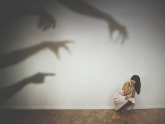 woman frightened by the shadows of hands of demons