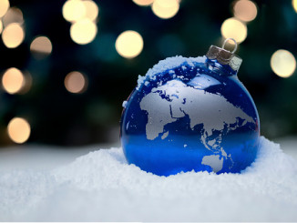 A Christmas ornament in the snow depicting the Eastern Hemisphere