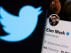 FILE PHOTO: A photo illustration shows Elon Musk's twitter account and the Twitter logo