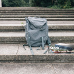 Books and backpack in a schoolyard