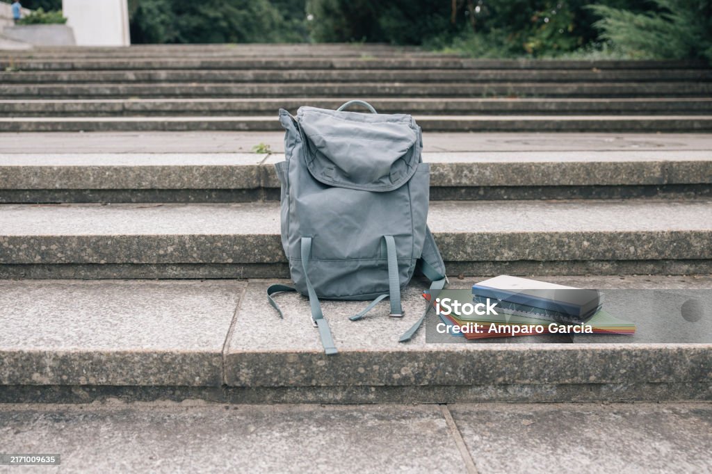 Books and backpack in a schoolyard